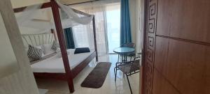 a bedroom with a bunk bed and a window at Seaview homestay on Third avenue beach apt- nyali in Mombasa +10 photos
