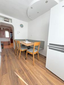 a kitchen and dining room with a table and chairs at Sinteu 3 bedroom apartment - 6PAX in Şinteu +10 photos