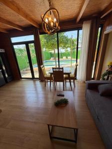 a living room with a couch and a table at Wooden Villa Eilin 3 in Tirana