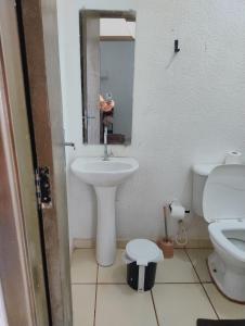a bathroom with a sink and a toilet at Pedacinho do céu 2 in Dourados