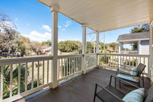 a porch with two chairs and a bench on it at Charleston 3BR Home · 3 Baths · Porches · Dogs OK in Charleston