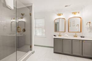 a bathroom with two sinks and a shower at Charleston 3BR Home · 3 Baths · Porches · Dogs OK in Charleston