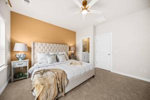 a bedroom with a large bed and a ceiling fan at Sweetgrass Row at Cane Bay in Summerville
