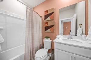 a bathroom with a toilet and a sink and a mirror at Sweetgrass Row at Cane Bay in Summerville +35 photos
