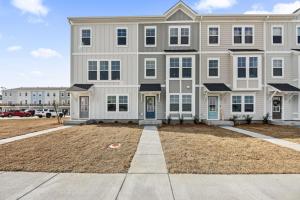 a large house with a large yard in front of it at Sweetgrass Row at Cane Bay in Summerville