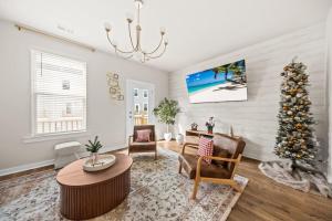 a living room with a christmas tree in it at Sweetgrass Row at Cane Bay in Summerville