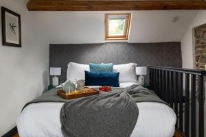 a bedroom with a large bed with a tray on it at Lovely 2 Bedroom Countryside Retreat in Shelve