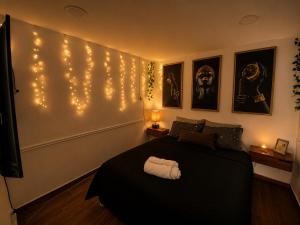 a bedroom with a bed with lights on the wall at Yui Loft cómodo para pareja o estancia tranquila in Pachuca de Soto