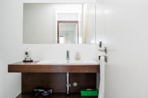 a bathroom with a sink and a mirror at Canhas Ocean View in Ponta do Sol +43 photos