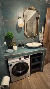 a bathroom with a sink and a mirror at J&B Suites in Kavála +33 photos