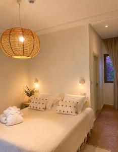 a bedroom with a bed with white sheets and pillows at Dar Tanja in Tangier +70 photos