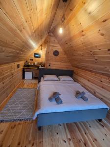 a bedroom with a bed in a wooden cabin at Eagle's View Cabin in Plav