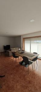 a large room with a table and chairs in it at 2 Bedrooms Apulia Front Beach Flat in Apúlia