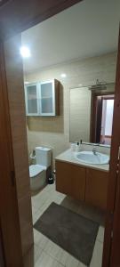 a bathroom with a sink and a toilet and a mirror at 2 Bedrooms Apulia Front Beach Flat in Apúlia +23 photos
