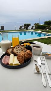 a plate of food on a table next to a pool at Oia Mar & Relax in Oya