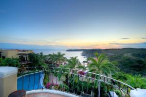 a view of the ocean from the balcony of a resort at Las Palmas Oceanfront Villas and Casitas in Santa Cruz Huatulco