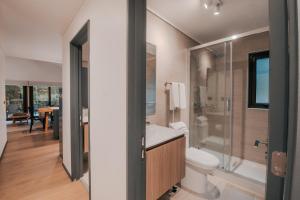 a bathroom with a toilet and a sink and a shower at Cabañas Parque Futangue in Lago Ranco +28 photos