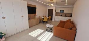 a living room with a couch and a table at Sea Apartments in Łeba