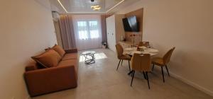 a living room with a couch and a table at Sea Apartments in Łeba