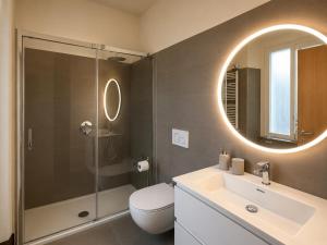 a bathroom with a toilet and a sink and a mirror at Casa Vacanza Saint George - Hotel San Giuseppe Group in Cernobbio