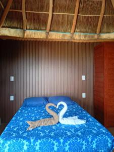ein Bett mit zwei aus Handtüchern geformten Schwänen in der Unterkunft Playa de Carmil in Rincón de Guayabitos + 84 Fotos