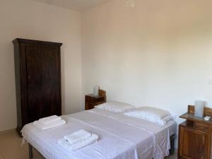 a bedroom with a bed with towels on it at Terrazzo Vista Mare Mozzafiato in Cariati