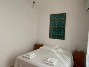 a bedroom with a bed with two towels on it at Terrazzo Vista Mare Mozzafiato in Cariati