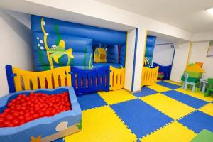 a childs bedroom with a bed and a table at Dipendenza Hotel Regal in Rimini