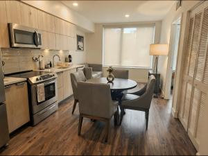 a kitchen with a table and chairs in a kitchen at Premier Downtown Koreatown Apartment in Los Angeles