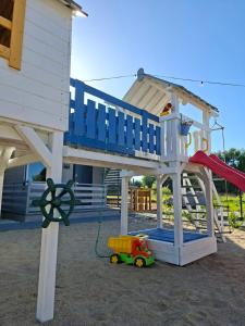 a play house with a slide and a toy truck at Sielska Przystań in Gąski