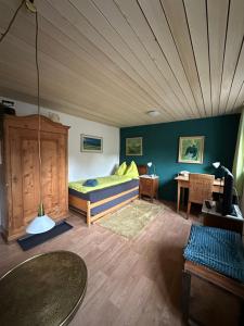 a room with a bed and a table in it at Pension Chesselberg in Buckten