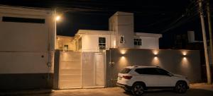 a white car parked in front of a garage at night at Yui Loft cómodo para pareja o estancia tranquila in Pachuca de Soto