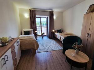 a hotel room with two beds and a table at Station rooms Trenčín in Trenčín