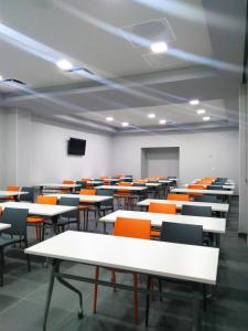 an empty lecture room with tables and chairs at Life Hotel in Oaxaca City