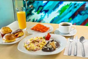 a table with two plates of food and a cup of coffee at Life Hotel in Oaxaca City