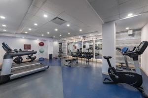 a gym with treadmills and ellipticals in a room at Four Points by Sheraton Manhattan Midtown West in New York