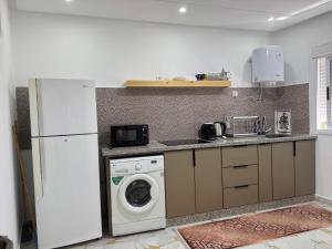 a kitchen with a refrigerator and a washing machine at Dalal house in Chefchaouen