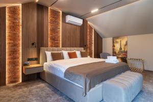 a bedroom with a large bed and a wall mounted television at Hotel Chateau Cojusna in Cojuşna +55 photos