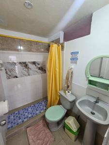 a bathroom with a toilet and a sink at Mí Oficina in Puerto Ayora +45 photos