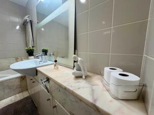 a bathroom with a sink and a toilet and a mirror at Polana View Apartment I in Maputo +6 photos
