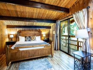 a bedroom with a bed in a room with wooden walls at Forest View Chalet in Glacier
