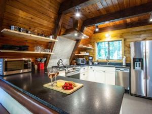 a kitchen with a counter with a glass of wine at Forest View Chalet in Glacier