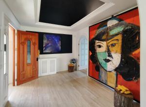 a room with a large painting of a woman on the wall at Oia Mar & Relax in Oya