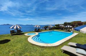 a swimming pool with a view of the water at Garden Suite in Oya +28 photos