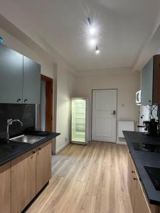a kitchen with a sink and a counter top at Fajrant Rooms Katowice in Katowice