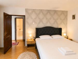 a bedroom with a large bed with white sheets at Vila Iepurasul Sinaia in Sinaia +174 photos