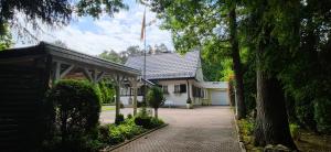 a white house with a flag on top of it at Villa Albert in Euskirchen