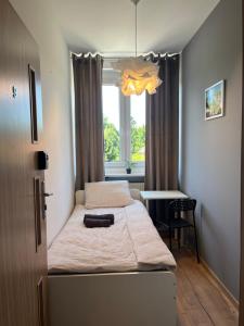 a bedroom with a bed and a window at Fajrant Rooms Katowice in Katowice