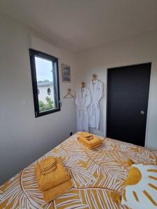 a bedroom with a bed with towels on it at Studio Cotentin Evas'yon in Feugères +24 photos