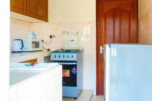 a kitchen with a stove and a microwave at Cherve BnB in Nakuru